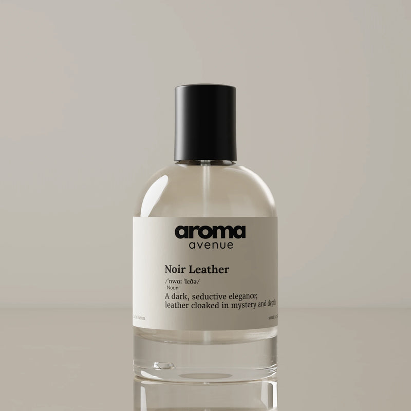 Perfume bottle labeled 'aroma avenue - noir leather Noir Leather' on a neutral background